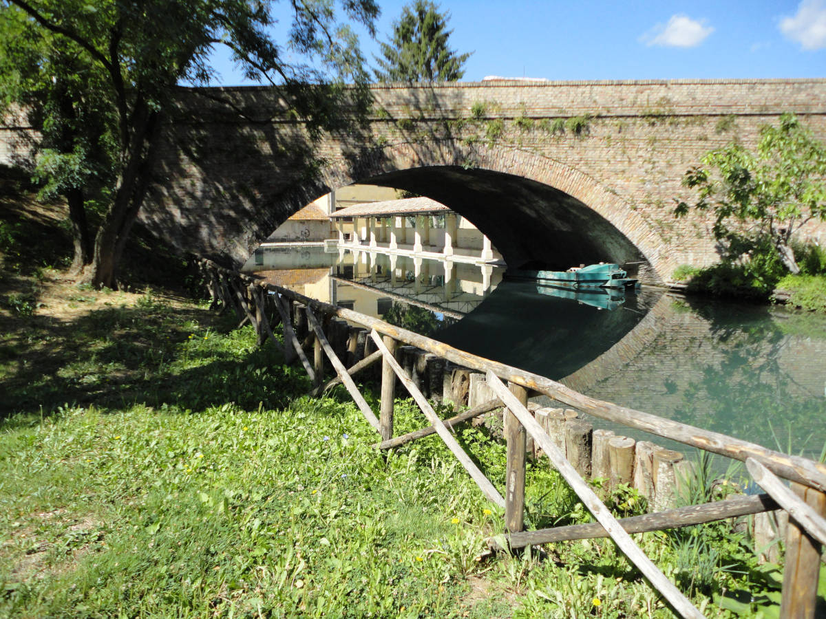 image shows: The ancient washhouse seen from beneath a bridge leading into Bevagana